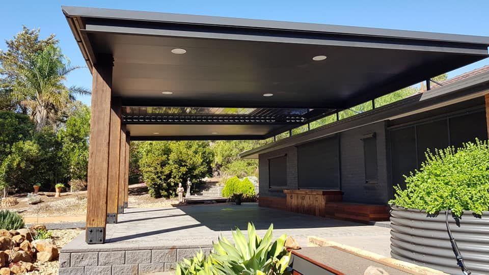 A Modern Outdoor Patio Cover With a Dark Roof — Crowfoot Constructions in Dubbo, NSW
