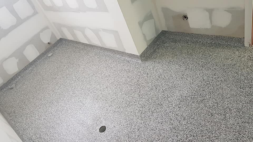A Room Under Construction With Gray Granite-look Speckled Epoxy Flooring — Crowfoot Constructions in Dubbo, NSW