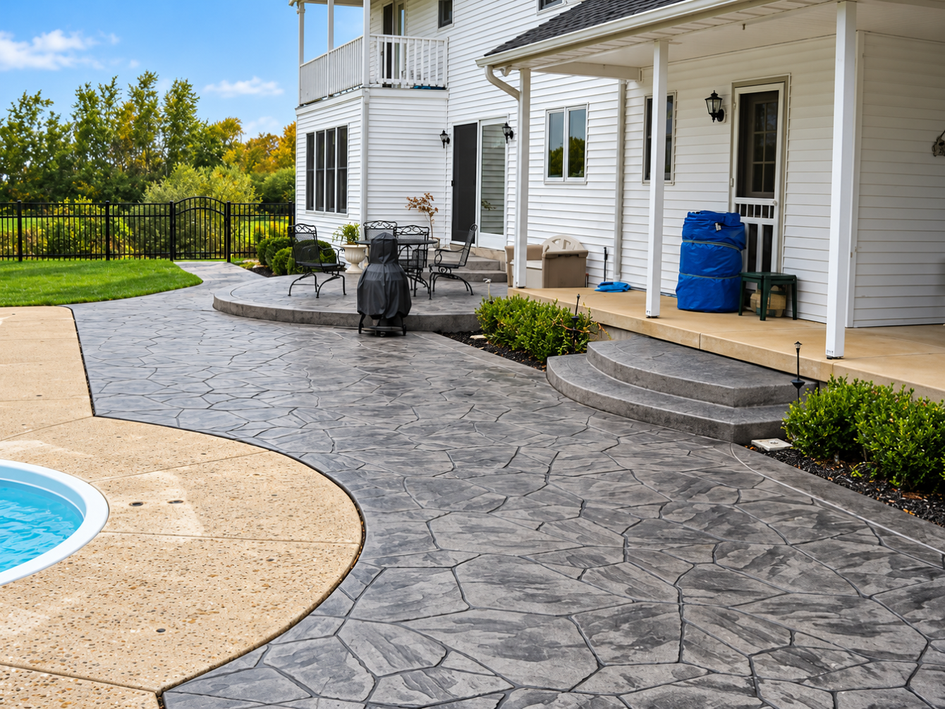 Finished stamped concrete patio surrounds home after Concrete Services in Eagan, MN created a neat outdoor living space.