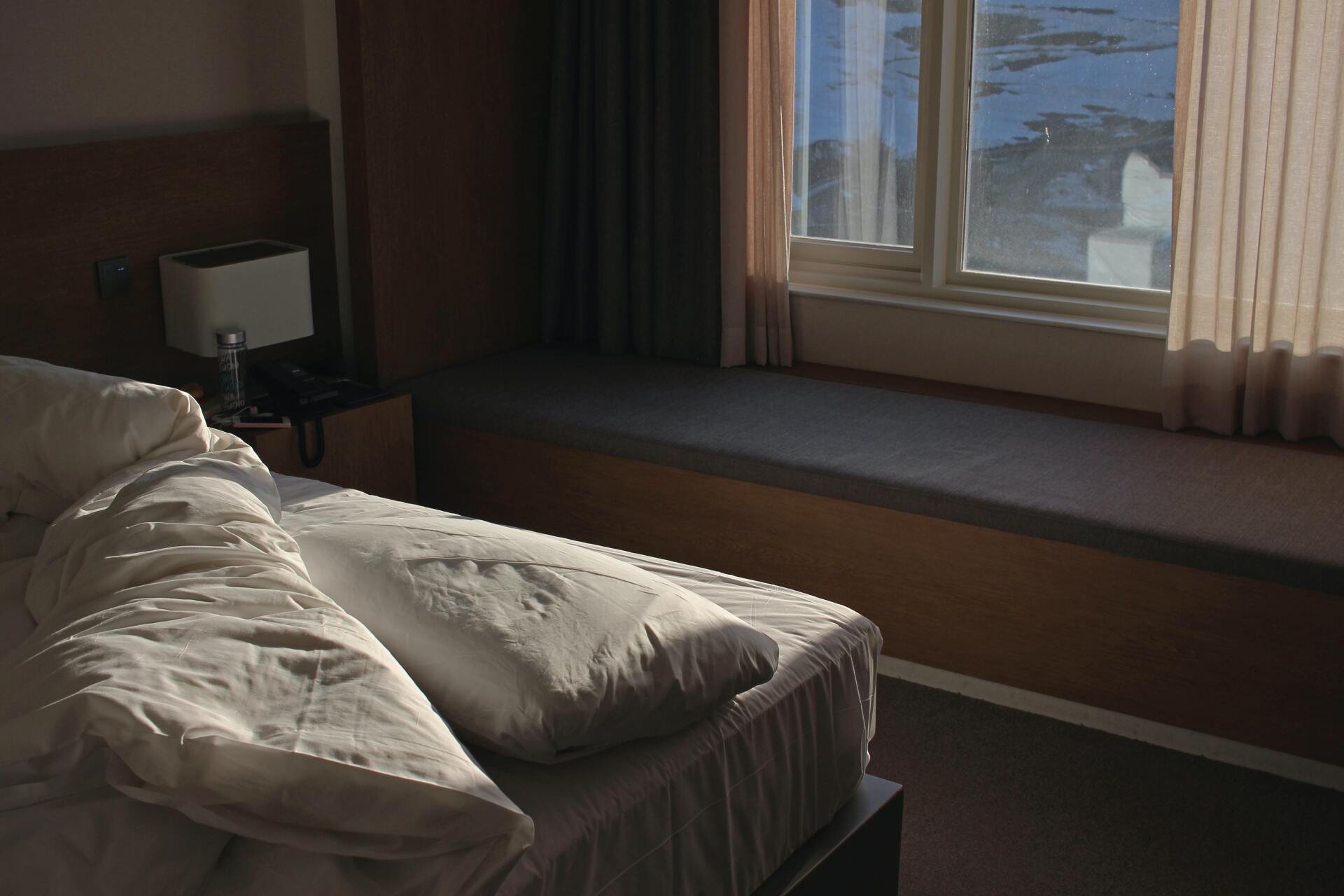 Hotel Room with Half Made Bed