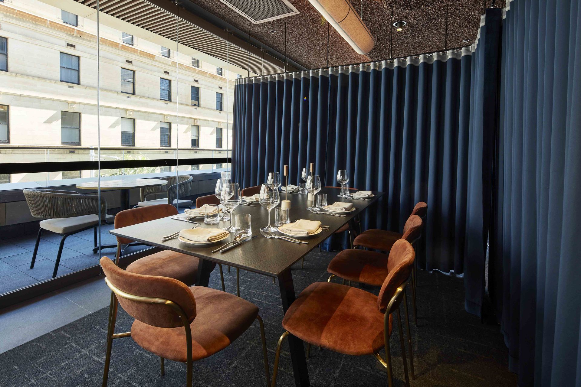 Set dining table with brown chairs in a softly lit restaurant