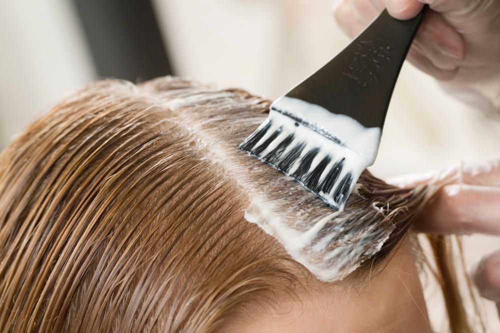 Hair color being applied to a client’s hair
