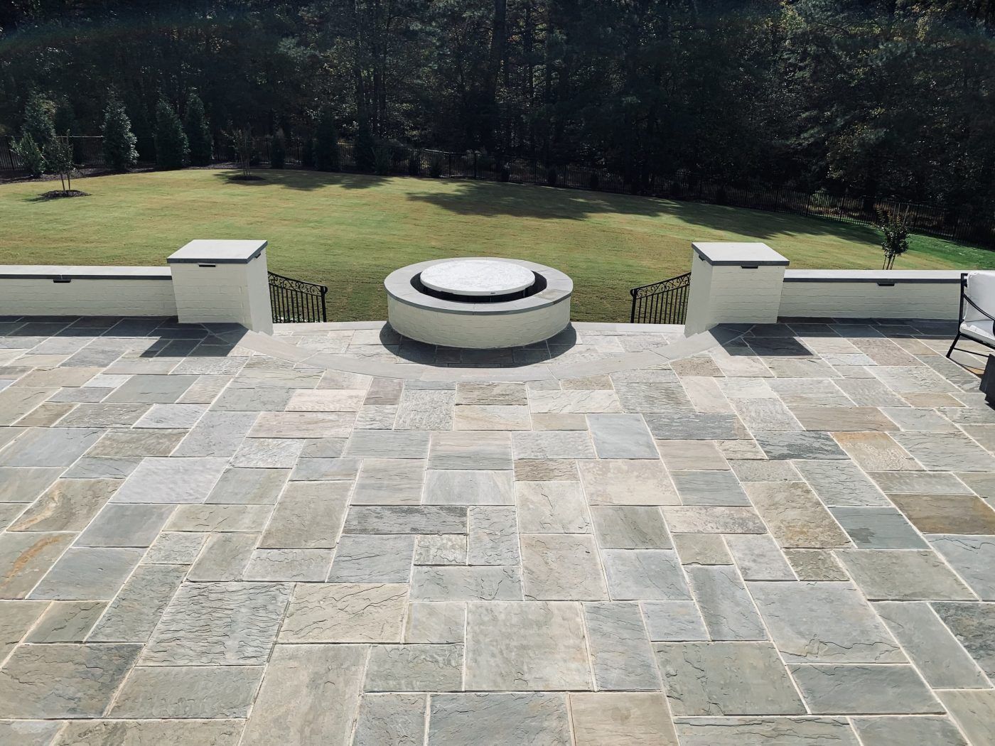 A patio with a fire pit in the middle of it