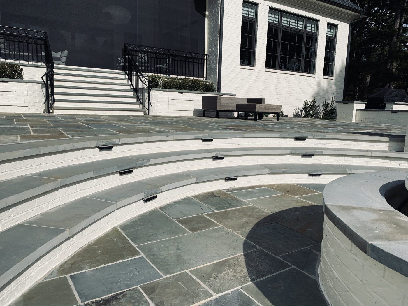 There is a fire pit in the middle of the patio