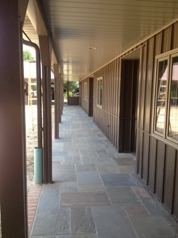 A long hallway between two buildings with a lot of windows