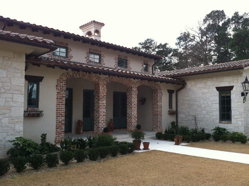A large white house with a brick porch