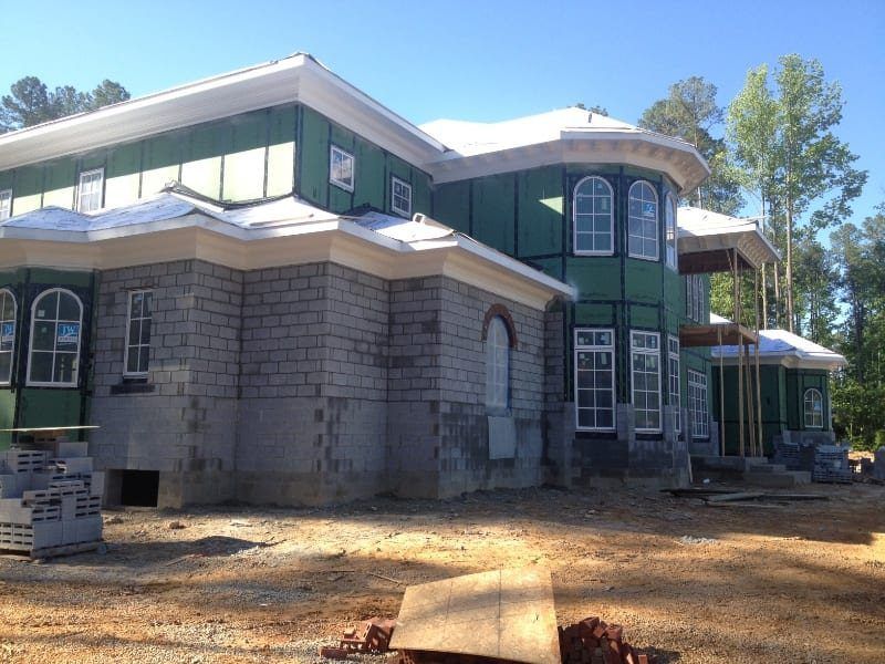 A large house is being built with a lot of windows