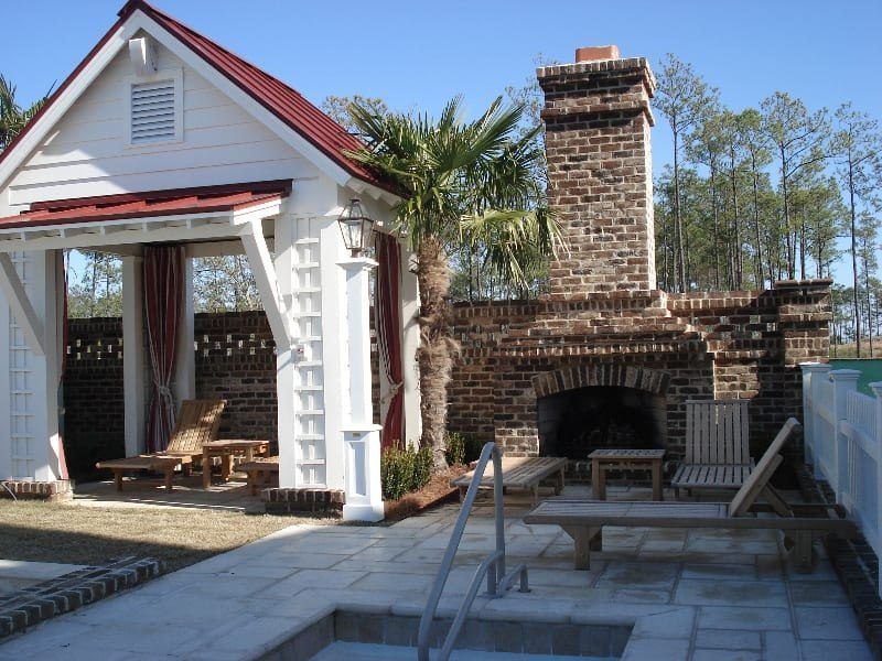 A white house with a red roof and a fireplace