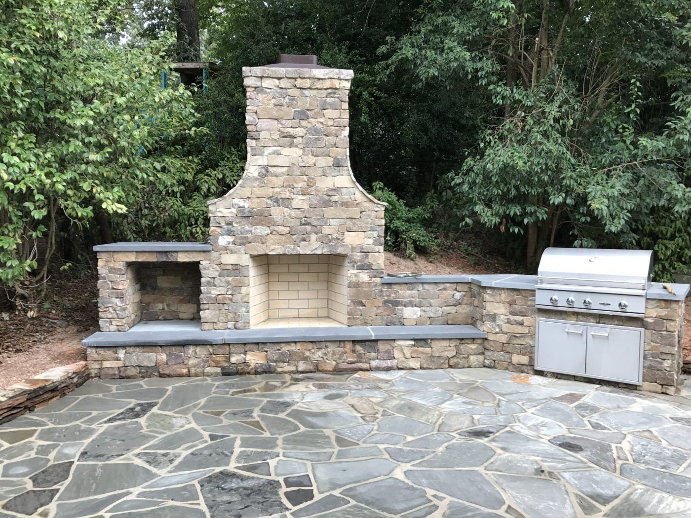 There is a fireplace and a grill on the patio.