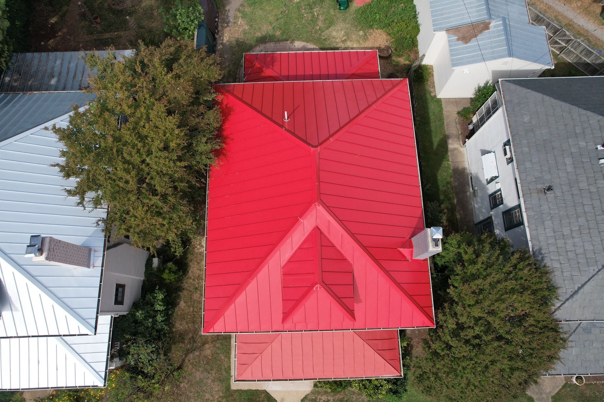 An aerial view of a house with a red roof