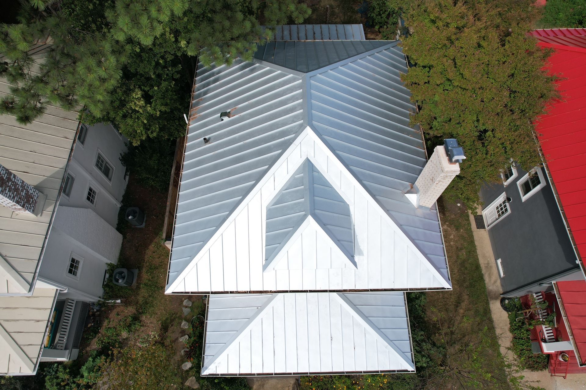 An aerial view of a house with a metal roof