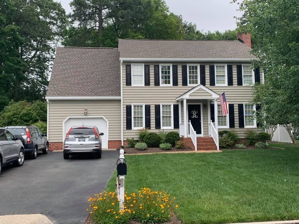 A large house with a car parked in front of it.