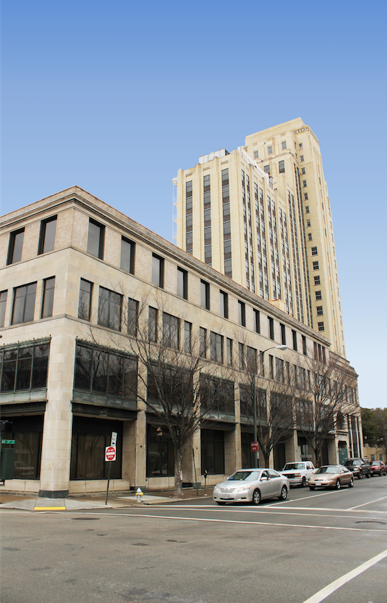 A large building with cars parked in front of it