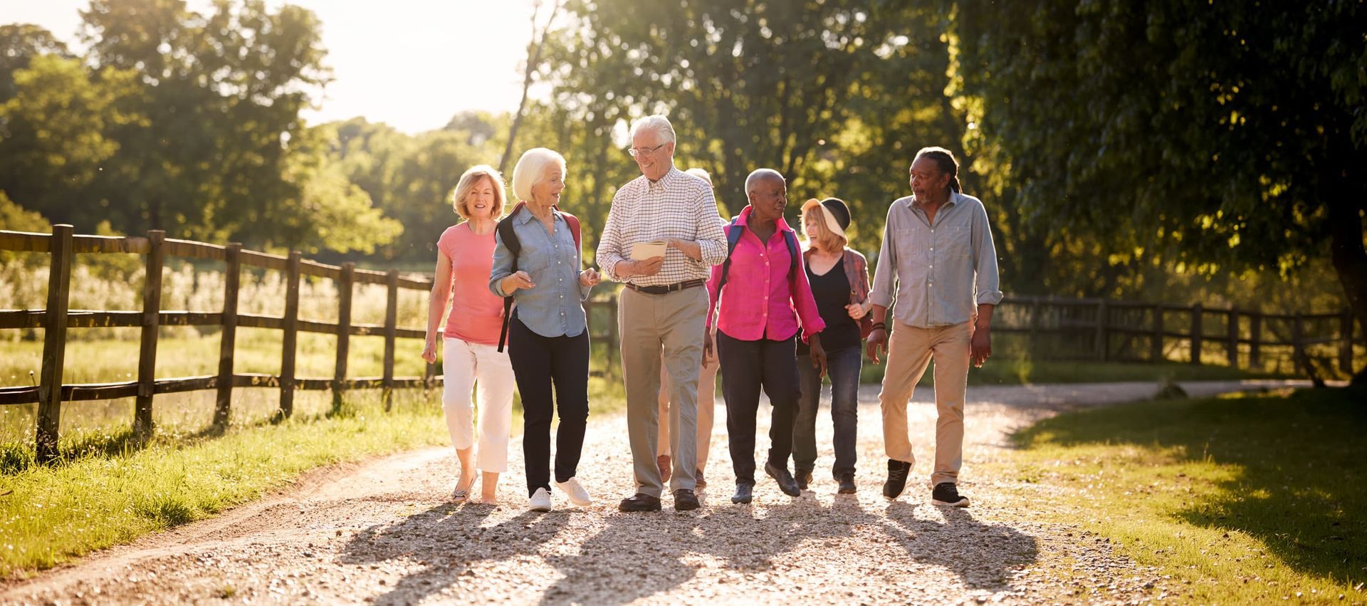 Group of active seniors walking together at Riverside Commons Independent Living community