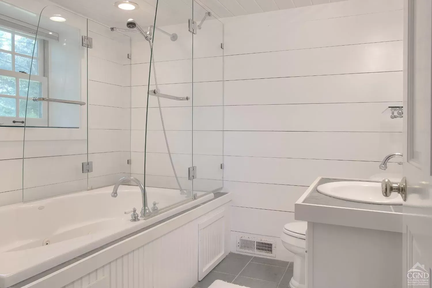 A bathroom with a tub , sink , toilet and shower.