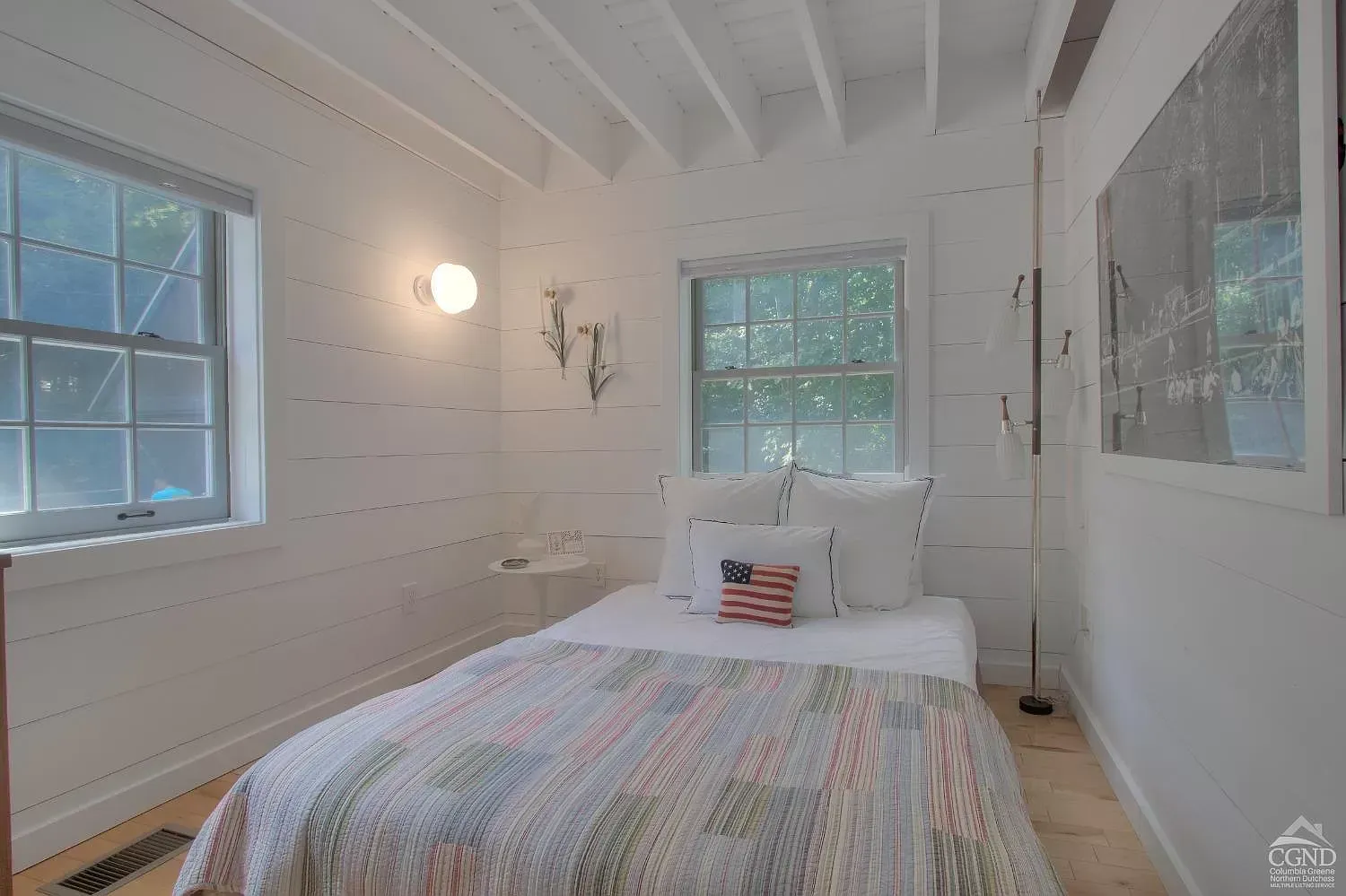 A bedroom with a bed and a window in it.