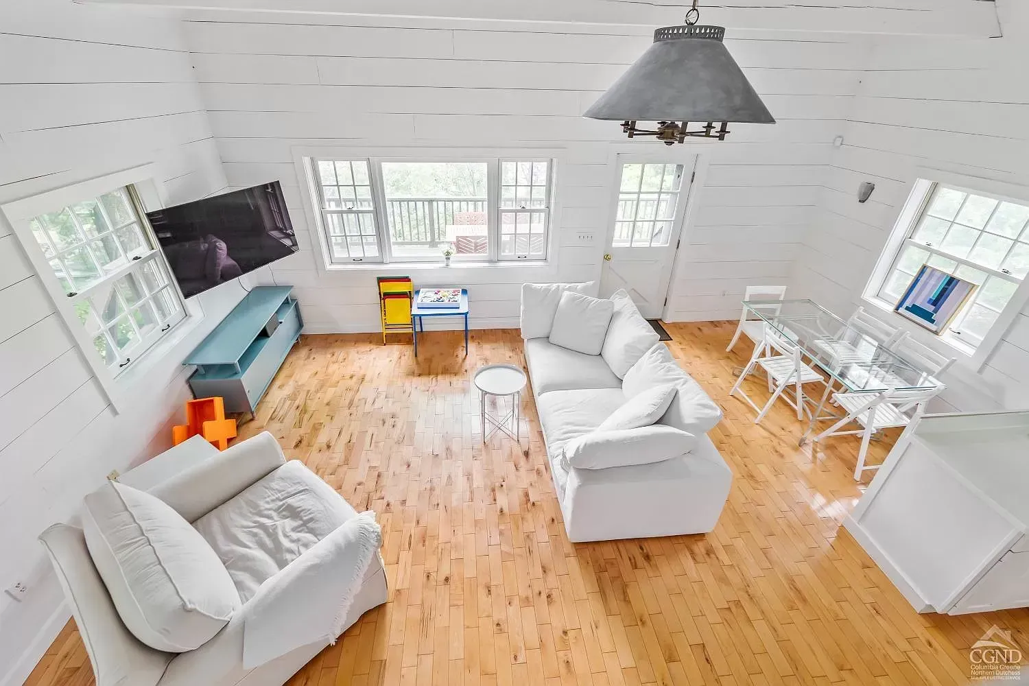 A living room filled with furniture and a flat screen tv.