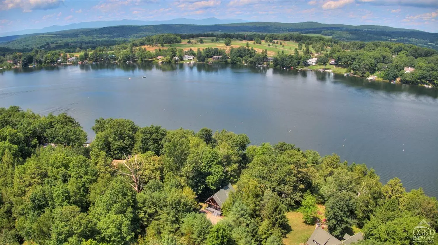 An aerial view of a large lake surrounded by trees.