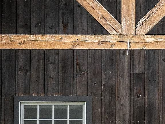 A wooden building with a window and a wooden roof.