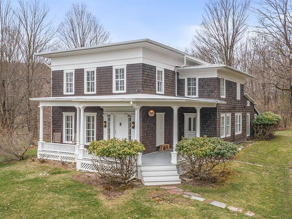 A large house with a porch and a lot of windows