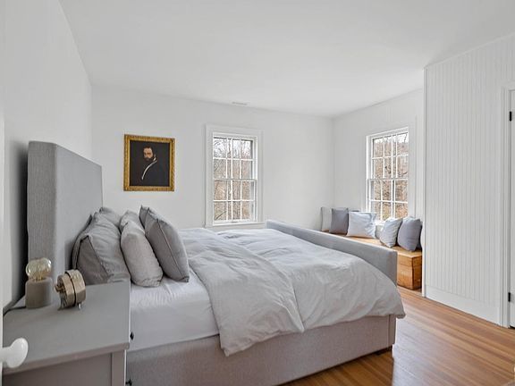 A bedroom with a large bed and a window seat.