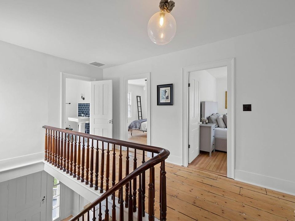 A staircase with a wooden railing leading up to the second floor of a house.