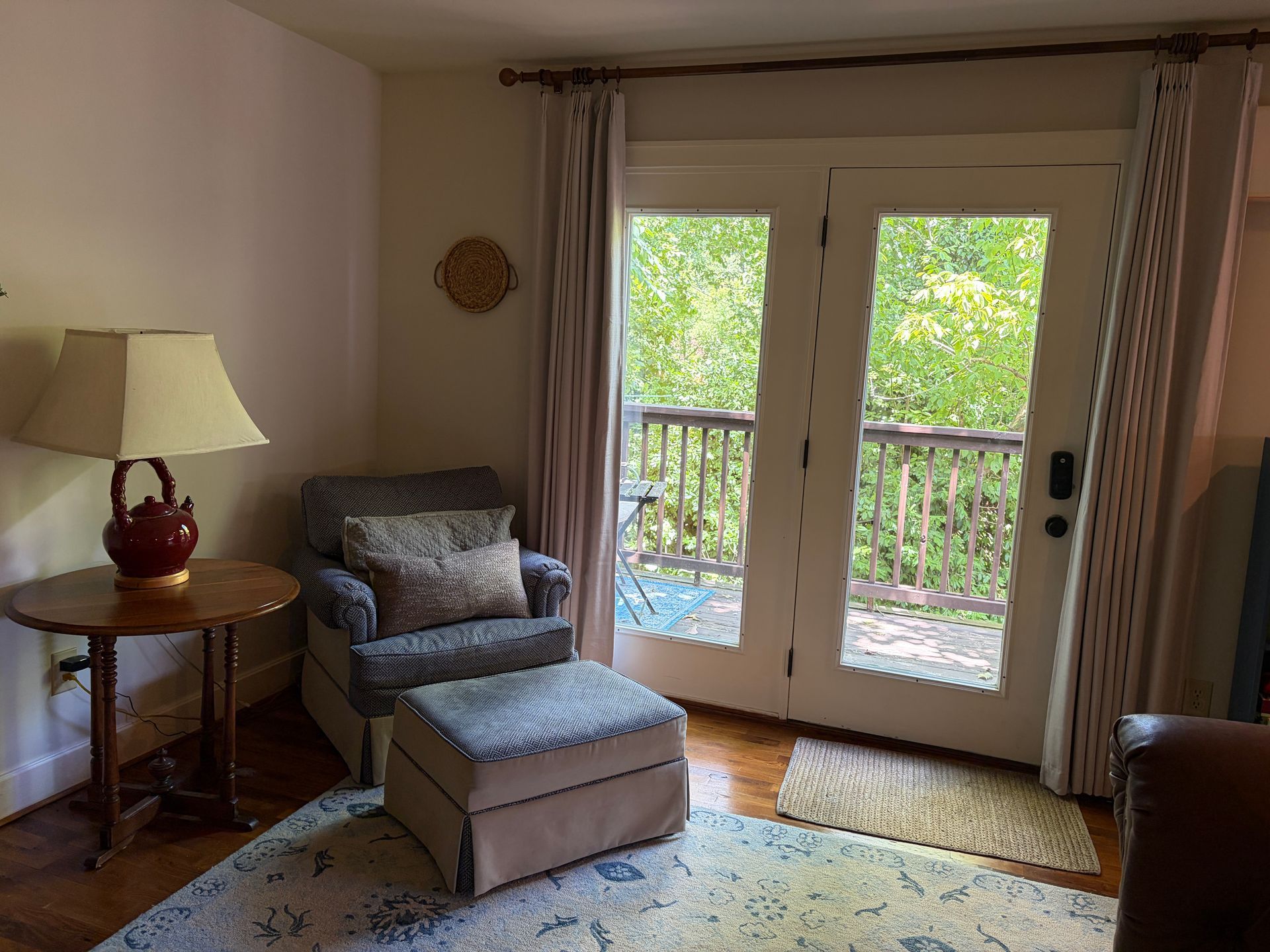 Loft reading nook with an armchair and French doors to the balcony