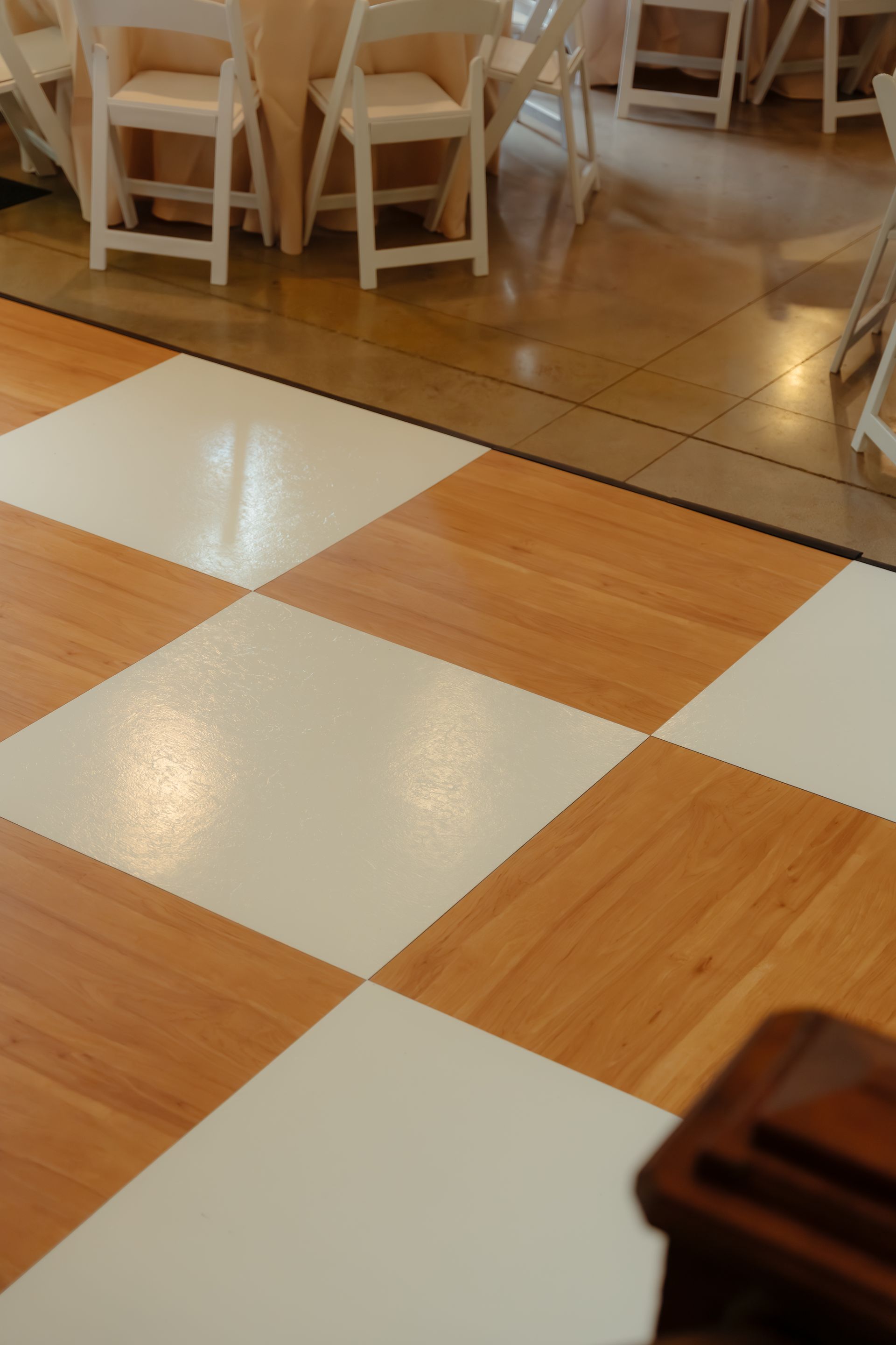 Close-up of a warm wood-tone checkered dance floor