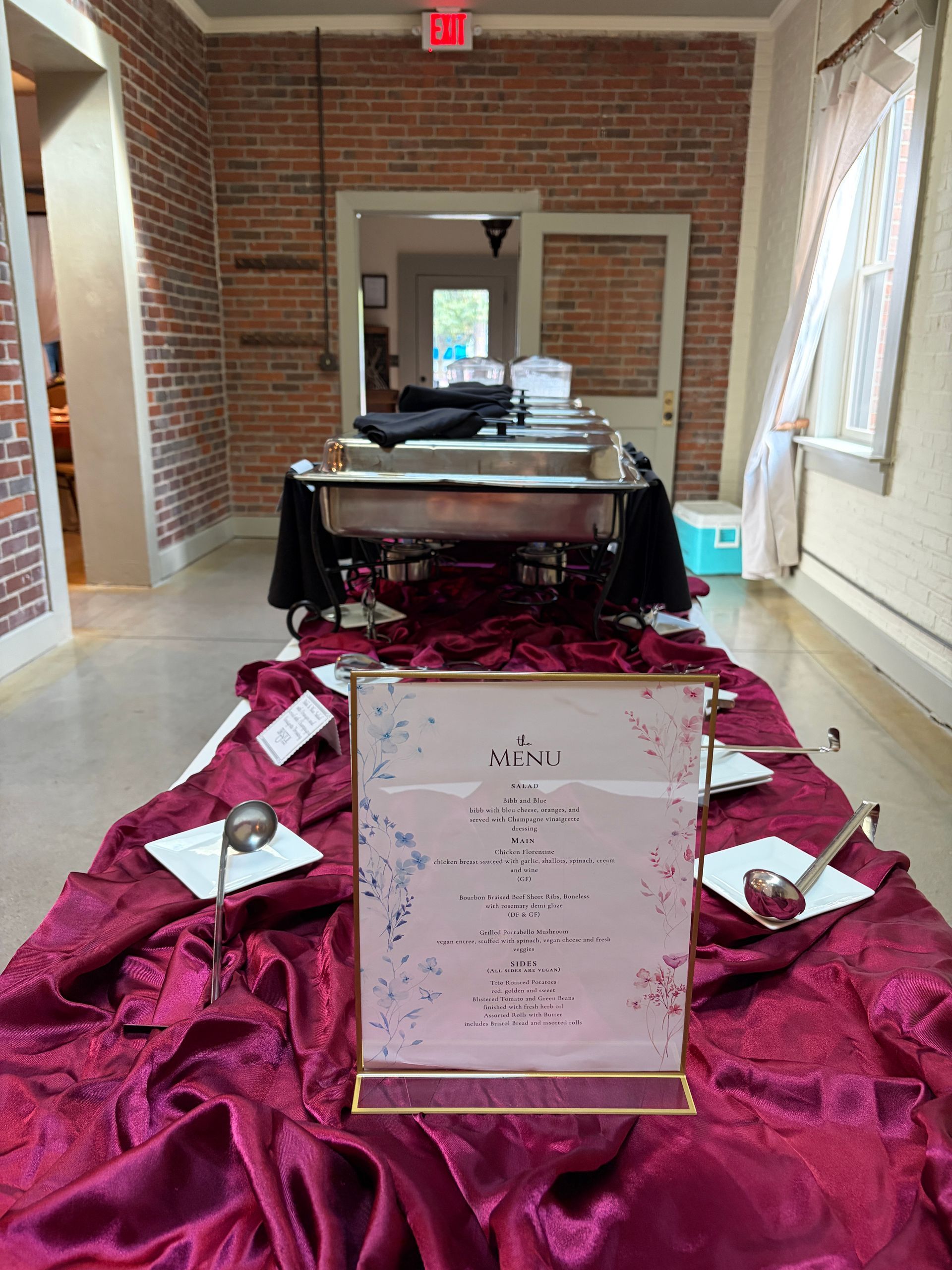 Dinner menu card on burgundy linen in a gold frame