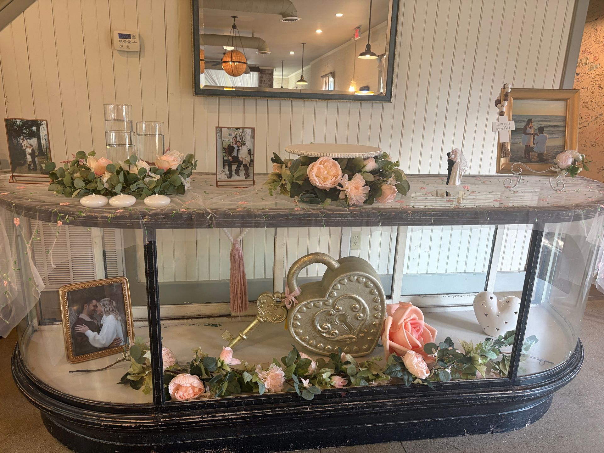 Memory table display with framed couple photos and cake