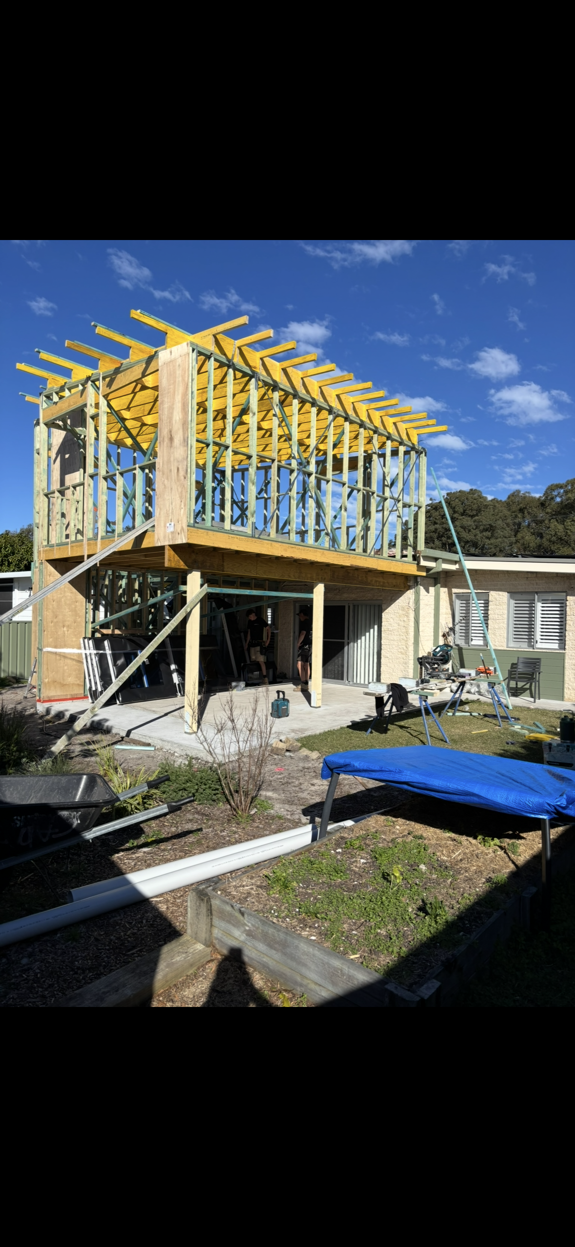 A Light Blue, Single-story Wooden Building With Multiple Windows and a Gray Roof, Set on a Slight Elevation With Green Vegetation and Blue Sky — Campbell Built in Nelson Bay, NSW