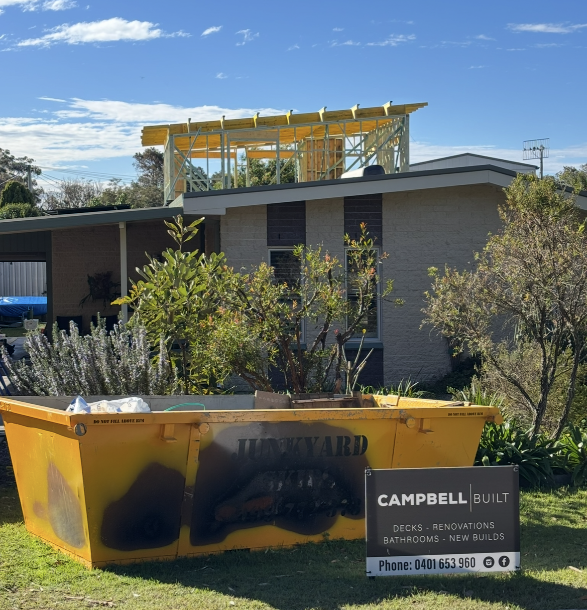 Modern House With a Dark Gray Roof and White and Gray Facade. a Wooden Pergola Shades the Glass Door and Windows — Campbell Built in Nelson Bay, NSW