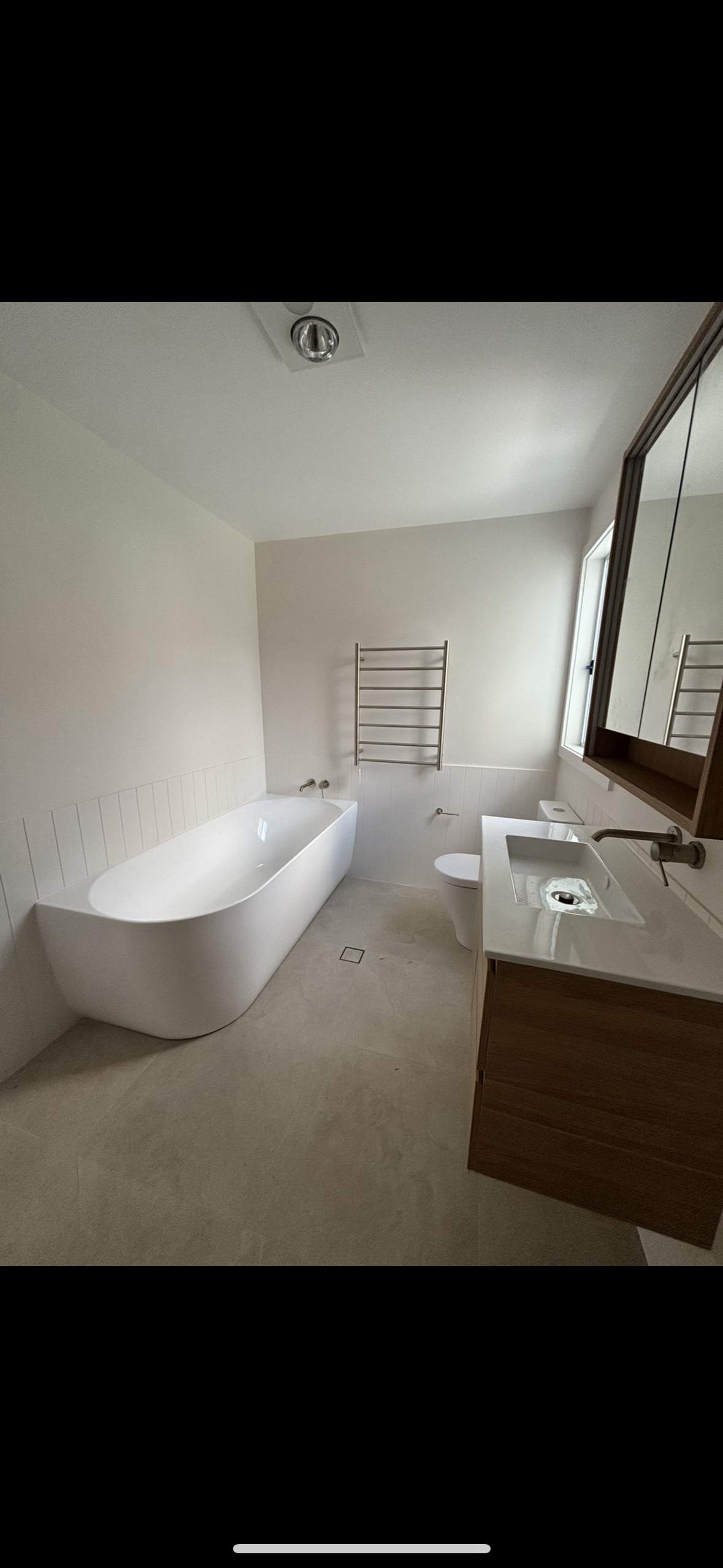 Modern White Bathroom With Double Vanity, Black Fixtures, and a Freestanding Tub Beneath a Window — Campbell Built in Newcastle, NSW