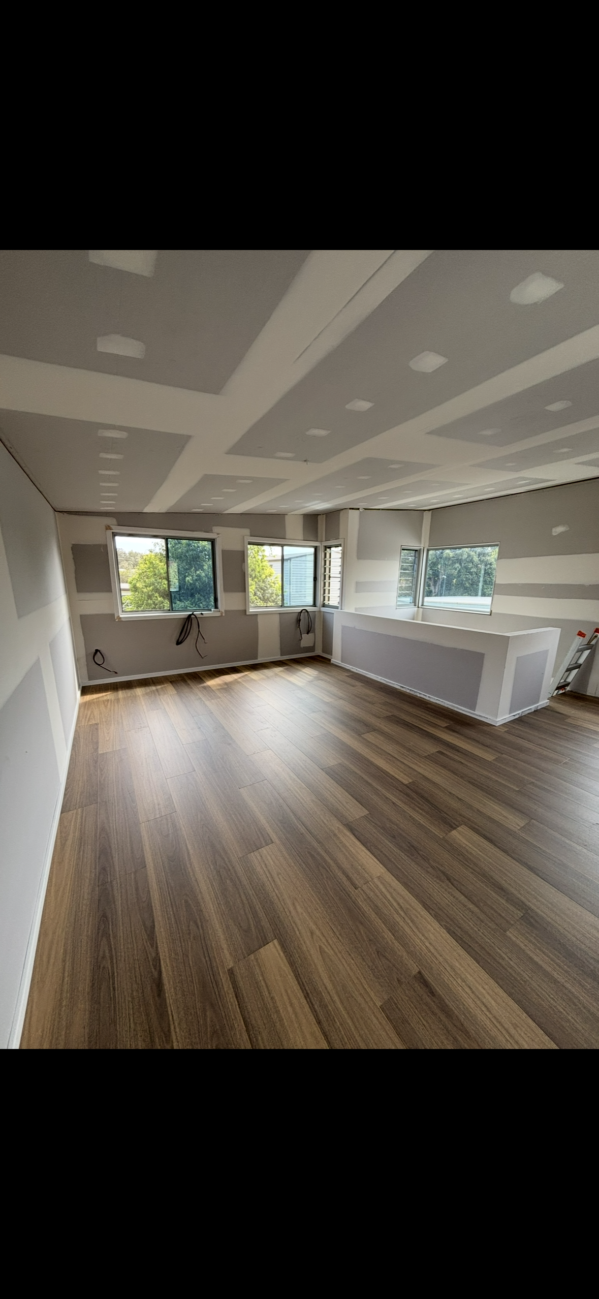 Room Under Renovation With Exposed Drywall, Insulation, and Building Materials — Campbell Built in Nelson Bay, NSW