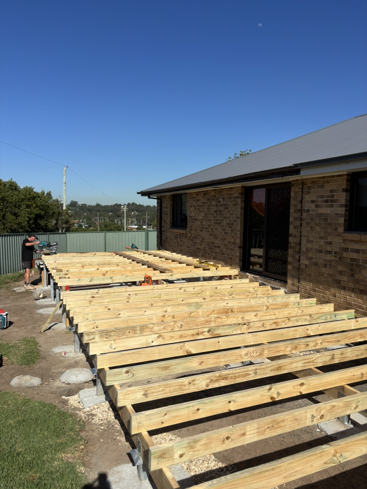 Construction Site With Steel Beams Supported by Temporary Scaffolding, Bracing a Brick Wall During Renovation. a Level Sits Atop One Beam — Campbell Built in Newcastle, NSW