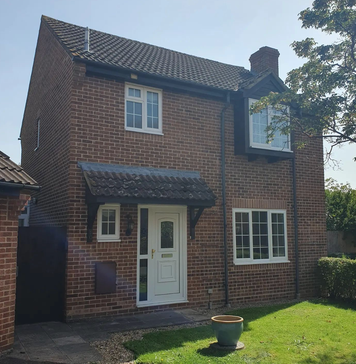 red brick property with windows displayed during day