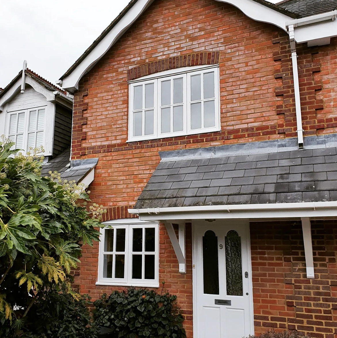 side view of a property with red brick and window showing