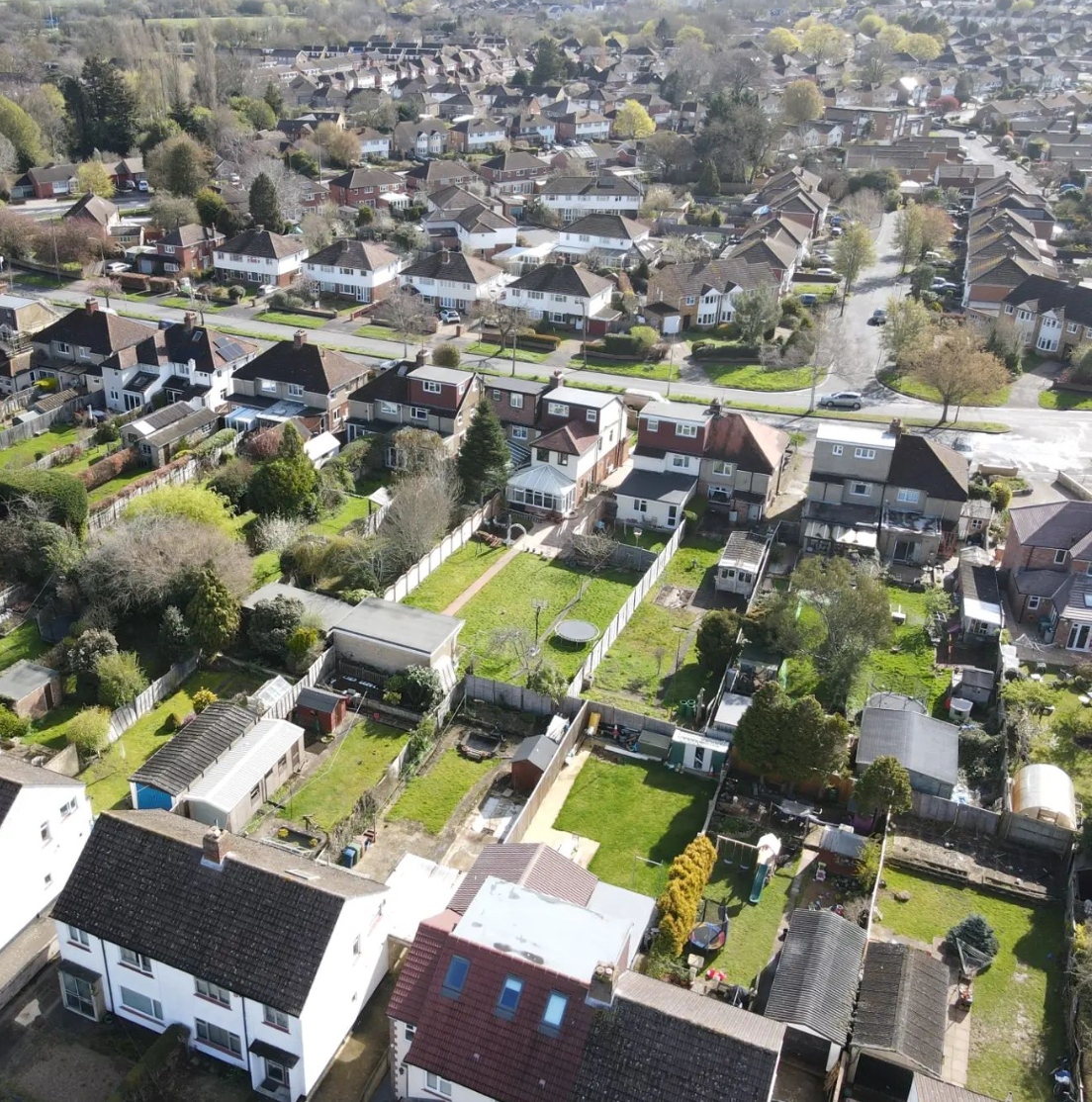 Overhead view of residential properties with gardens