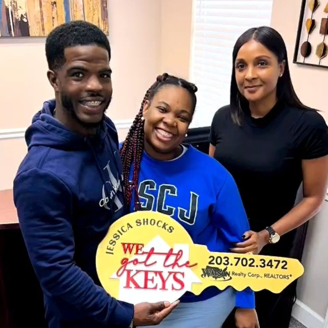 People holding a large key with