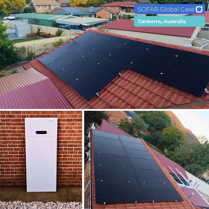 Solar panels on a red roof and a white battery unit on a brick wall, Canberra, Australia — Macleay Energy Solutions In Kempsey, NSW