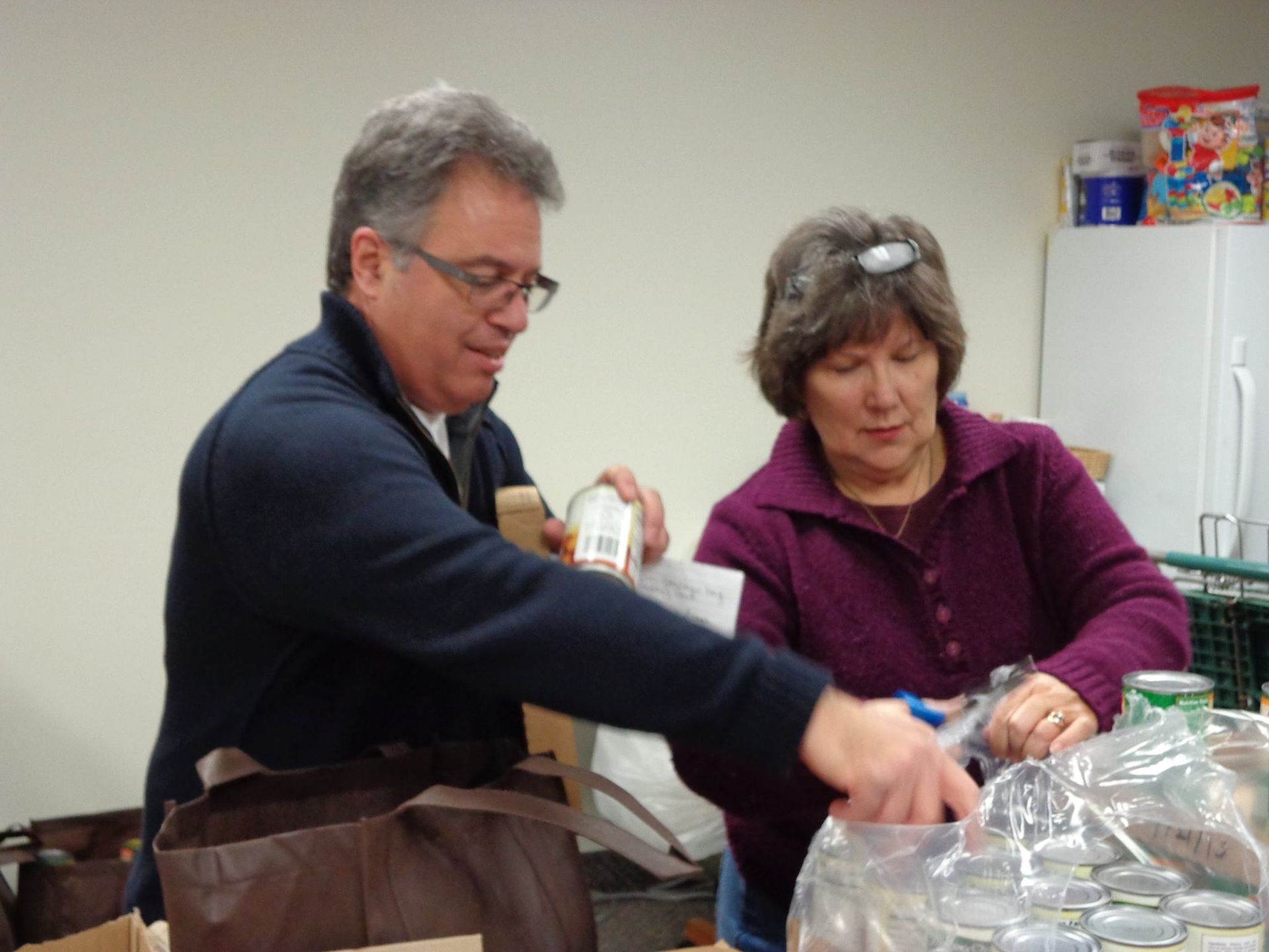 A man and a woman are working together in a kitchen