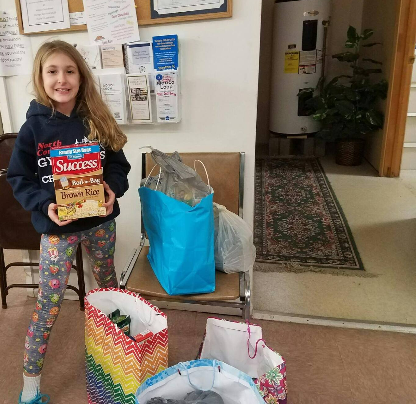 A little girl is holding a bag that says success on it