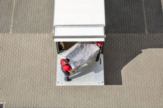 Two movers organizing Furniture and Receiving items at MUVR's short term storage facility
