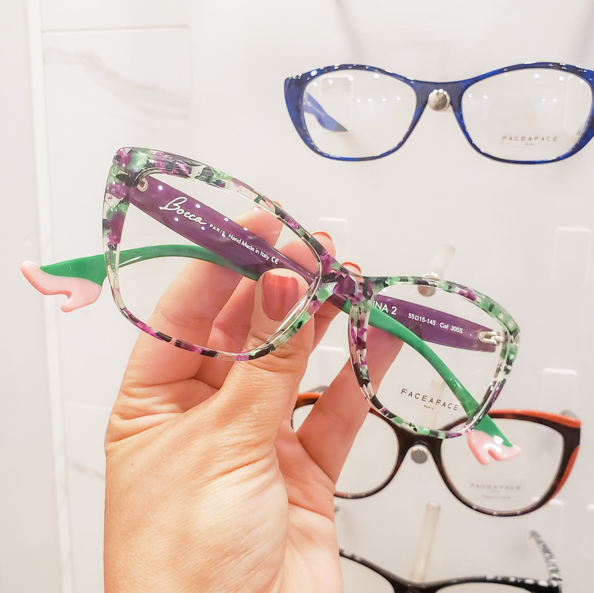 Cheerful man touching his stylish eye glasses — Noblesville, IN — Noble Optique