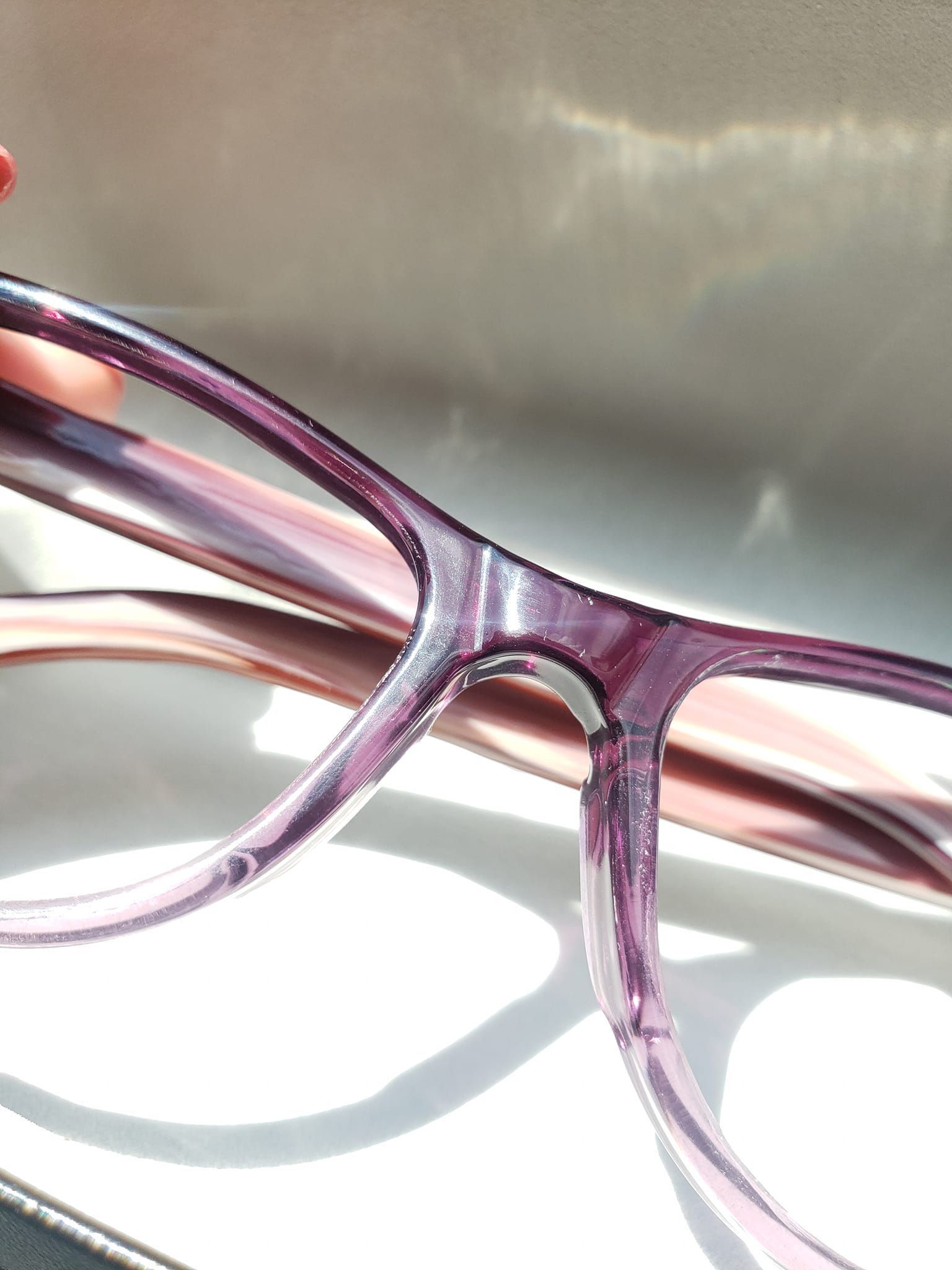 A person is holding a pair of glasses in their hand — Noblesville, IN — Noble Optique