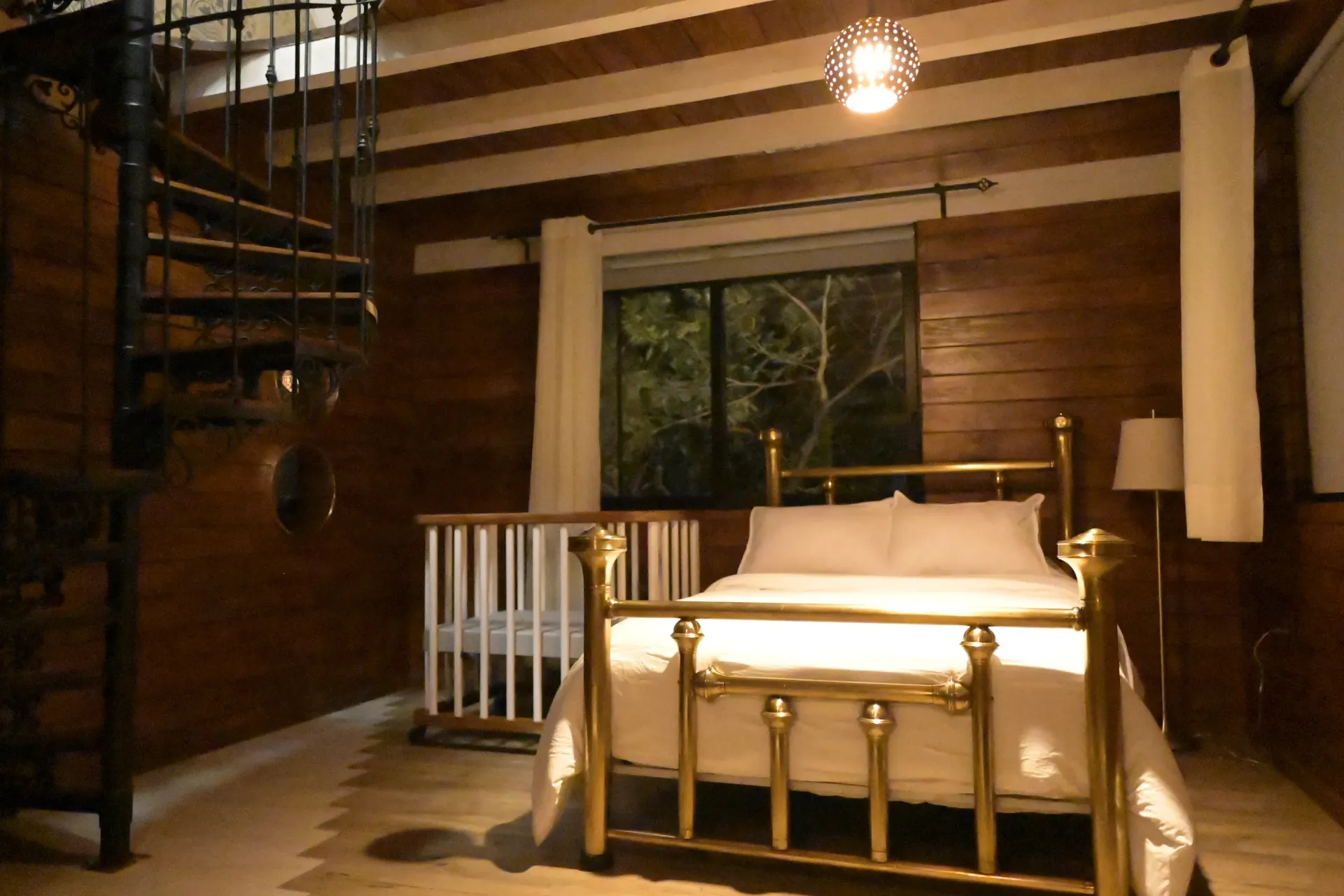 Un dormitorio con una escalera de caracol y una cama.
