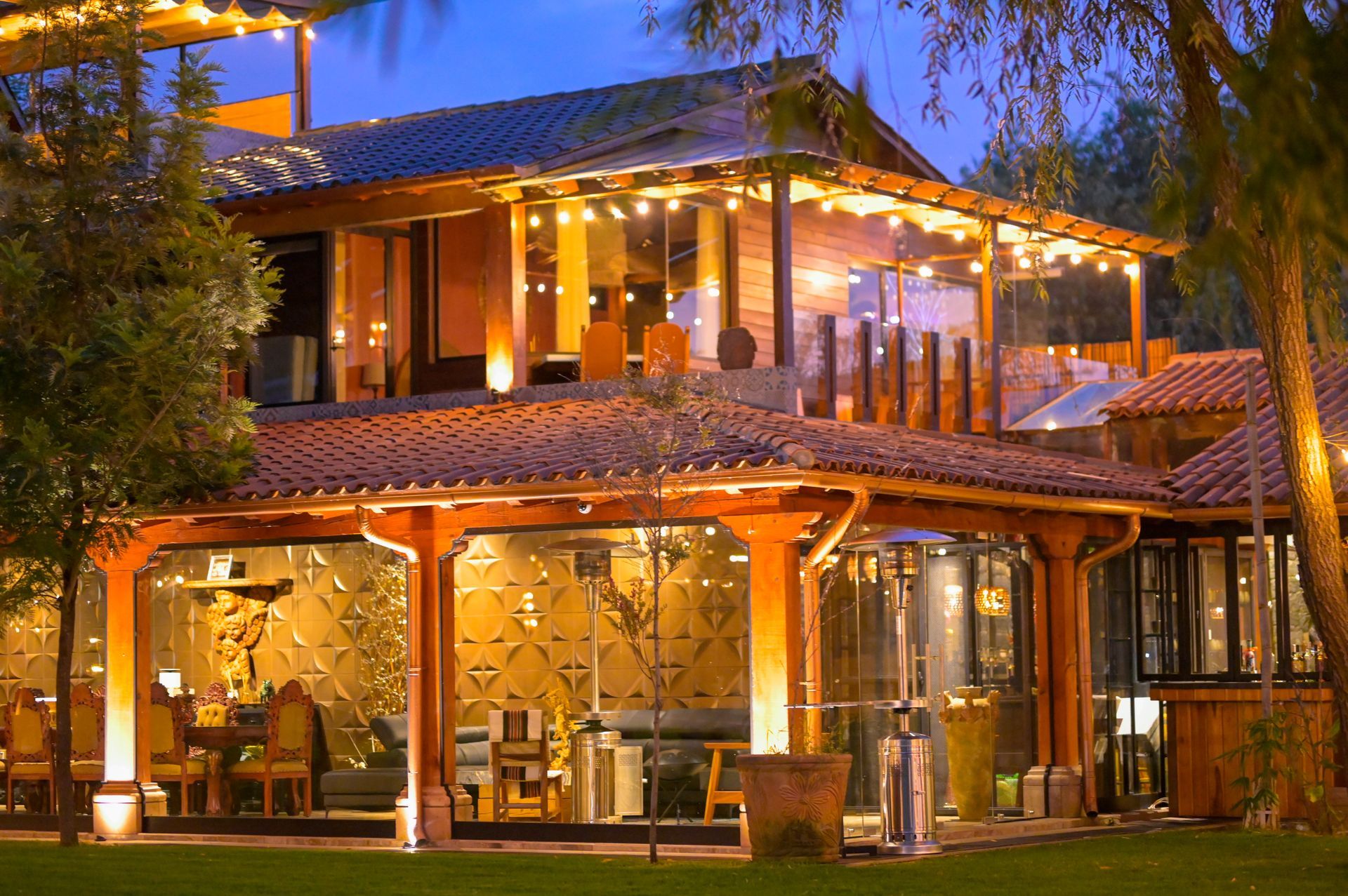 A large house with a lot of lights on it is lit up at night.