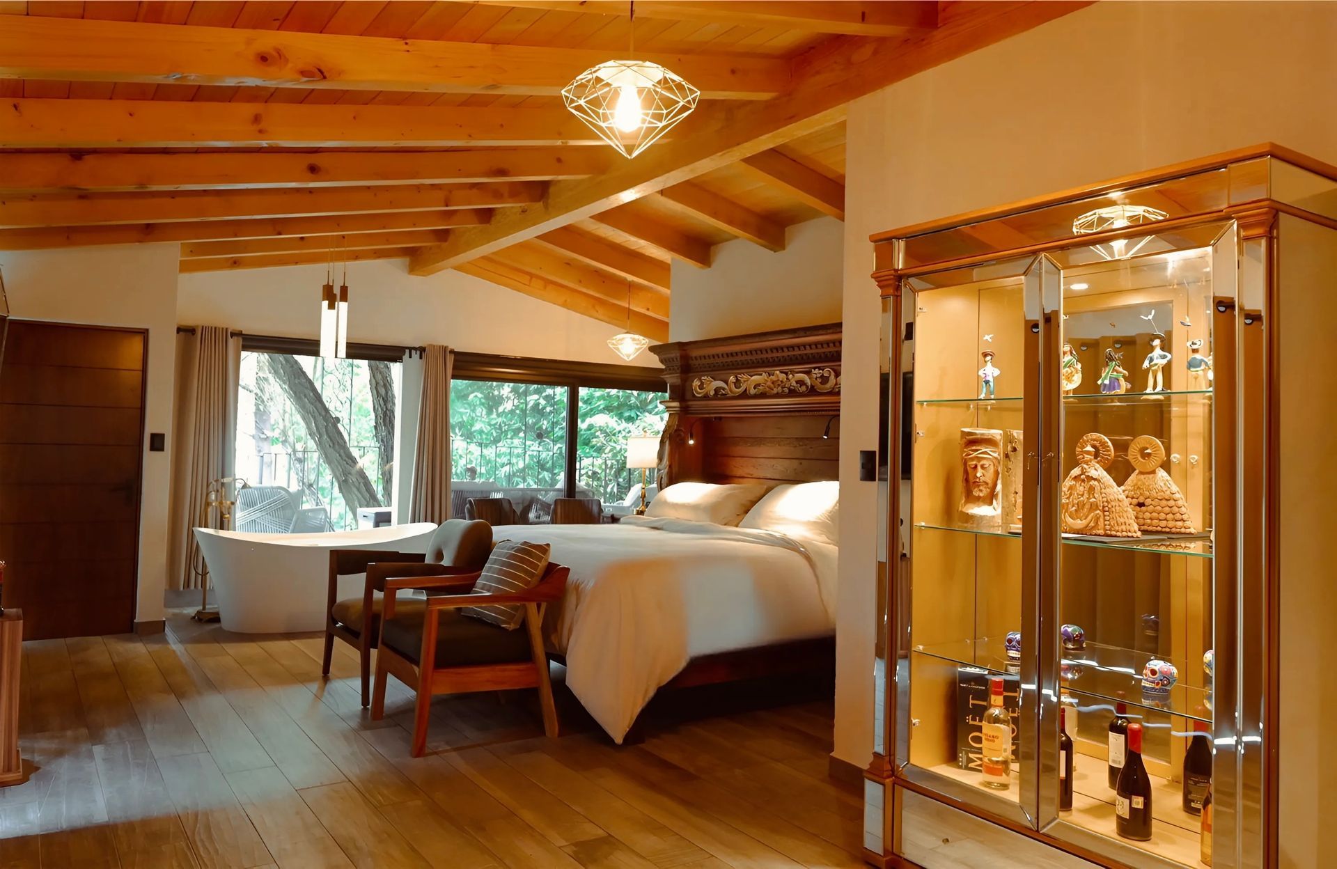 A bedroom with a large bed and a bathtub