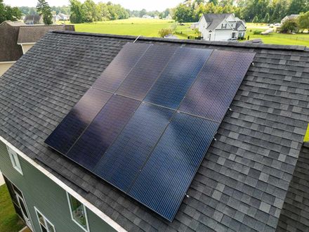 Solar panels installed on a dark asphalt shingle roof Solar panels installed on a dark asphalt shingle roof