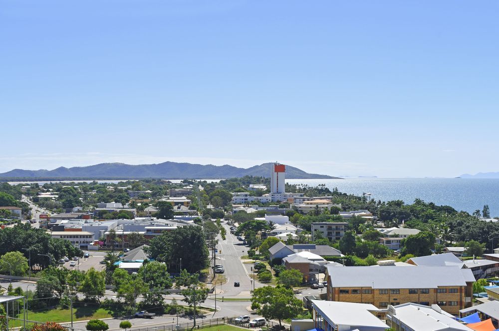 An Aerial View Of A City Near The Ocean With Mountains In The Background — Aaron Lee Painting Pty Ltd In Townsville City, QLD